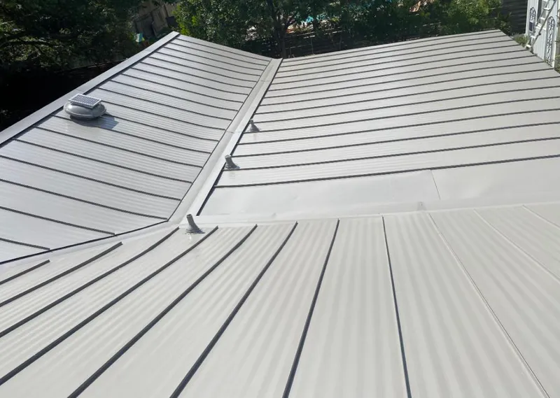 Solar attic fan installed on a metal roof for Roof Ventilation in Broadalbin